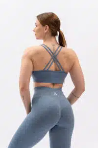 Female model wearing BLISS Top Blue — yoga to lifestyle