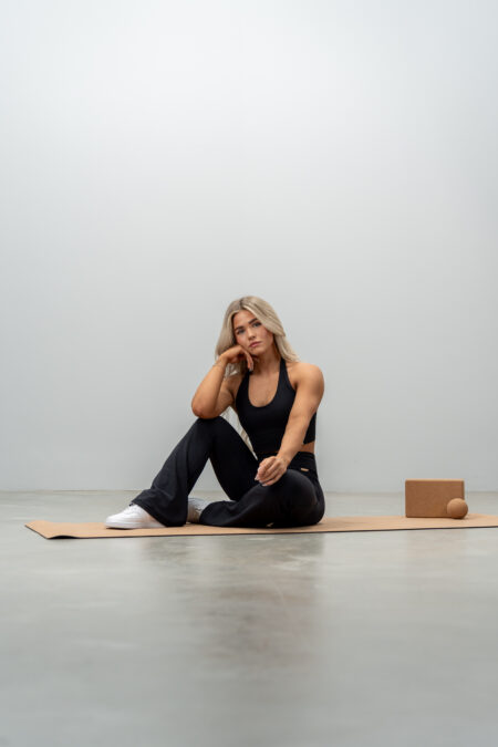 Woman sitting on a yoga mat
